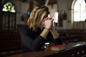 Woman praying in church